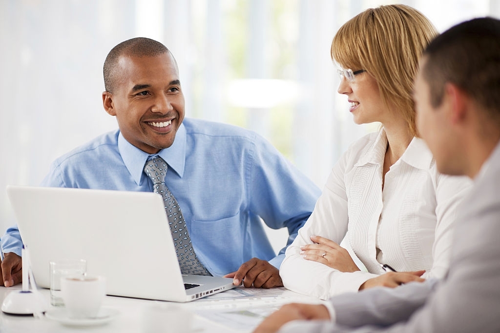 Smiling group of successful businesspeople on a meeting.